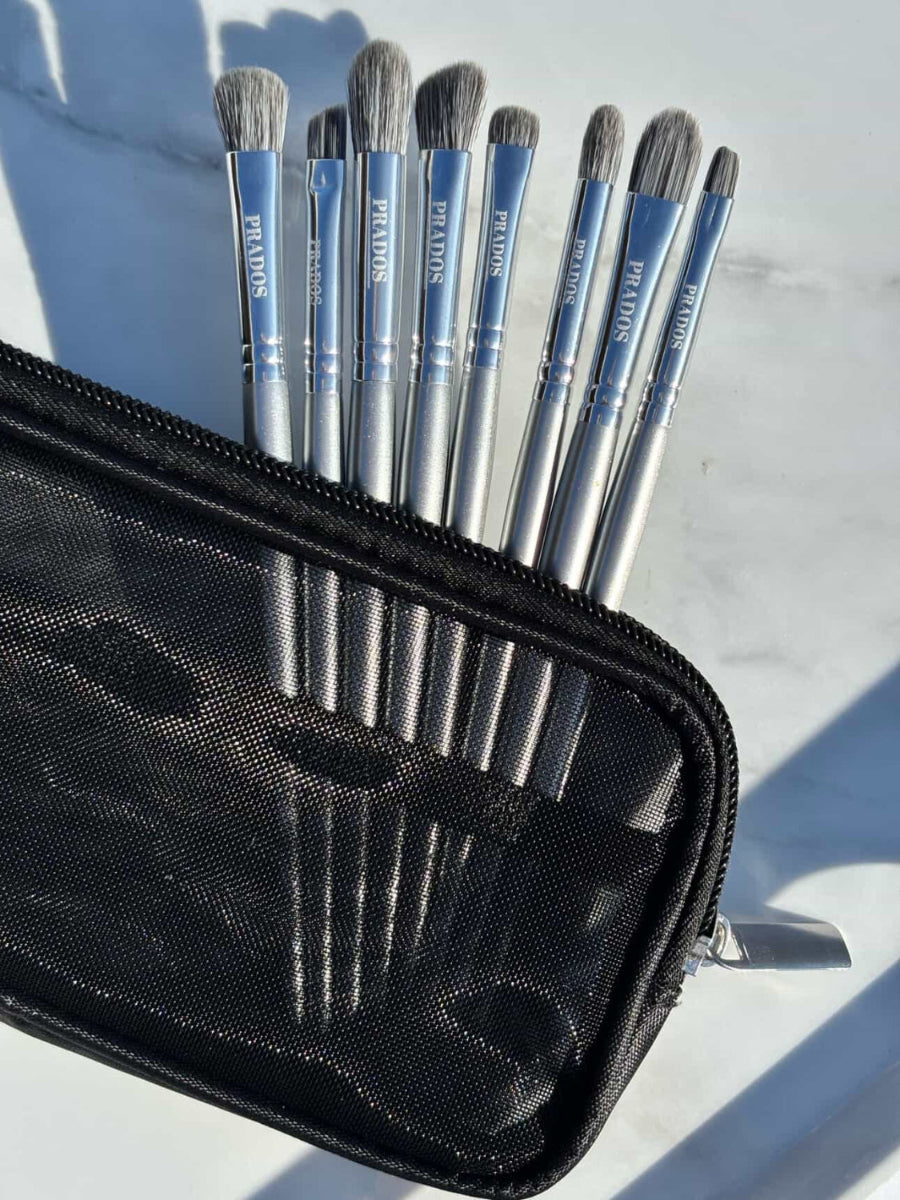 Set of makeup brushes in a black case on a light background